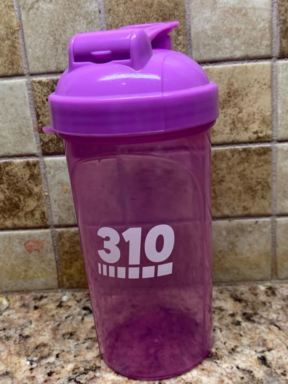 310 Nutrition branded protein shaker bottle in a pinkish purple color.